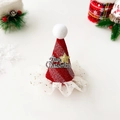 Detailed close-up of a festive red glitter Christmas hat hair clip with gold star detail - Star Stripes