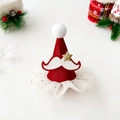 Close-up of a Christmas hat hair clip with red satin, white fur ball, and gold star detail - Star Beard