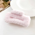Close-up of pink plush hair claw clip featuring soft faux fur texture and rectangular design - Light Pink