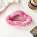 Close-up of a pink plush cloud hair claw clip on a white desktop with cozy decor - Pink