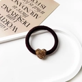 Detailed close-up of dark brown woven elastic hair tie with a gold heart-shaped crystal charm - Heart Pendant / Dark Coffee
