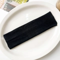 Detail shot of black elastic knitted yoga headband with premium vertical woven texture - Black