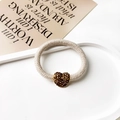 Detail of beige knit elastic hair tie featuring a sparkling gold rhinestone heart pendant - Heart Pendant / Beige