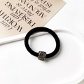 Close-up of black elastic hair tie featuring a square pendant with dark grey rhinestones - Square Decor Style / Black