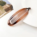 Macro view of amber gradient banana hair clip with dense teeth on white ceramic - 11.5CM / Transparent Amber