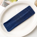 Detailed view of dark blue elastic knitted yoga headband on a ceramic tray - Navy Blue