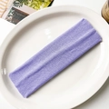 Close-up of lavender purple knitted headband with elastic ribbed texture on ceramic plate - Light Purple
