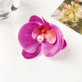 Close-up of artificial butterfly orchid hair clip with a large white faux pearl center - Pink Purple