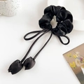Detail of elegant black satin scrunchie with long ribbons and tulip-shaped pendants - Black Tulip Pendant