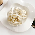 Detailed view of elegant cream white satin rose scrunchie on a white ceramic plate - Satin Rose Large Scrunchie / Off-white