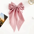Detail of dusty pink satin bow hair clip with elegant long ribbons on white background - Pink