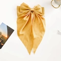 Detailed view of large champagne satin bow hair clip with long elegant ribbons - Bright Yellow