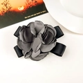 Close-up of elegant dark grey fabric rose hair claw clip with black satin ribbon bow - Fabric / Gray Duckbill Clip