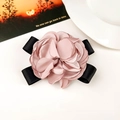 Detailed close-up of a dusty rose fabric flower hair claw clip with black satin ribbon - Fabric / Pink Duckbill Clip