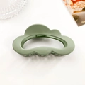 Macro shot of cloud-shaped matte green hair claw clip with hollow design and teeth - Matte Grass Green