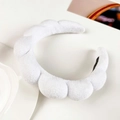 Macro view of white microfiber cloud sponge headband with soft bubble texture - White