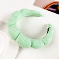 Close-up of mint green bubble headband with soft plush fabric and segmented quilting - Fruit Green