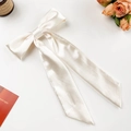 Elegant cream satin bow hair clip with long ribbons and premium silk texture - Apricot