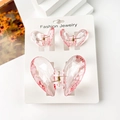 Detail of pink transparent heart hair clips set on display card with gold spring hinge - Transparent Powder Pink Heart Set