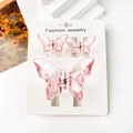 Detailed view of pink translucent butterfly hair claws in three-piece set on a card - Transparent Powder Pink Butterfly Set