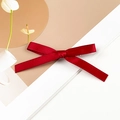 Detail view of a dark red satin bow hair clip with smooth texture on a minimalist background - Single Style / Burgundy