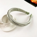 Detail view of sage green braided satin headband with sparkling silver rhinestone trim - Rhinestone Twist-Light Green