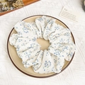 Detailansicht eines weißen Haargummis mit blauem Blumenmuster und weicher Stofftextur - Blau Blumendruck Haargummi (16.5cm)