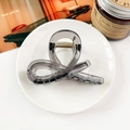 Elegant semi-transparent grey hair claw clip on a white plate with aesthetic lifestyle decor - Transparent Gray
