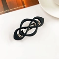 Macro view of matte black geometric hair clip with silver metal spring fastener - Crisscross Spring Clip-Matte Black
