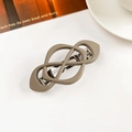 Close-up of matte taupe geometric hair clip with cross design and metal spring fastener - Crisscross Spring Clip-Matte Light Coffee