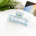 Close-up of clear acrylic hair claw clip with blue floral pattern on white plate - Blue Floral (8.5cm Square)