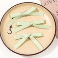 Three-piece mint green bow hair clips in a ribbon texture for side styling - Combination Style / Grass Green