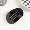 Dettaglio della pinza per capelli ovale nera con glitter fini su uno sfondo minimalista - PC / 10cm Clip Ovale - Nero Glitterato
