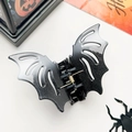 Detail shot of a black bat-shaped hair claw with glitter finish for Halloween parties - Glitter Black White (10cm)