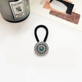 Macro detail of bohemian turquoise elastic hair tie with vintage carved metal button - Antique Silver Arrow Flower Green Turquoise