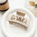 Close-up of a large matte rectangular hair claw clip in a soft beige milk tea color - Matte Light Coffee