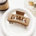 Detailed view of large matte caramel brown square claw clip with double layer hollow design - Matte Ginger