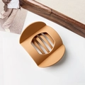 Macro view of matte caramel brown hair claw clip with modern minimalist hollow design - Matte Mustard Yellow