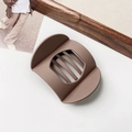 Macro shot of matte brown flat geometric hair claw with hollow slats and sleek texture - Matte Milk Coffee