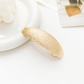 Detail showing gold hammered metal texture and curved design of this stylish hair clip - Hammered Crater Oval Gold