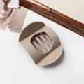 Detail view of a matte brown wide-body hair claw clip with multi-tooth design and grip texture - Matte Skin Tone