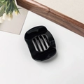 Close-up of a glossy black hair claw clip with five teeth on a minimalist background - Glossy Black