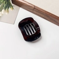 Detail shot of a dark brown translucent square hair claw clip on a white background - Glossy Dark Brown