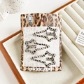 Detailed close-up of leopard print hollow star hair clips set on white velvet tray - Star Style / Leopard - Shooting Star