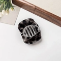 Detailed view of large dark grey leopard print resin hair claw clip for thick hair styling - Glossy Gray Leopard