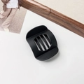 Close-up of matte black flat round claw clip with minimalist hollow grid design - Matte Black