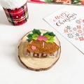 Close-up of a Christmas pudding hair claw clip on a rustic wooden log base for festive styling - Bell-Shaped