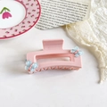 Detail view of pink square hair claw clip with blue butterfly accents and glossy finish - 9cm Pink Square - Blue Butterfly