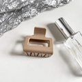 Detail of square matte beige hair claw clip with rectangular cutout on white background - Khaki