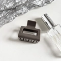 Detail of a matte dark coffee rectangular hair claw clip on a minimalist gray background - Grey Brown